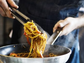 Chef cooking spaghetti in the kitchen